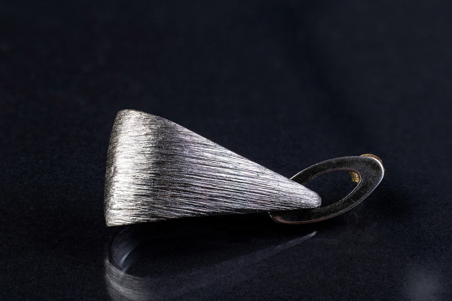 Sterling silver ring resting on black fabric background – minimal and handcrafted aesthetic