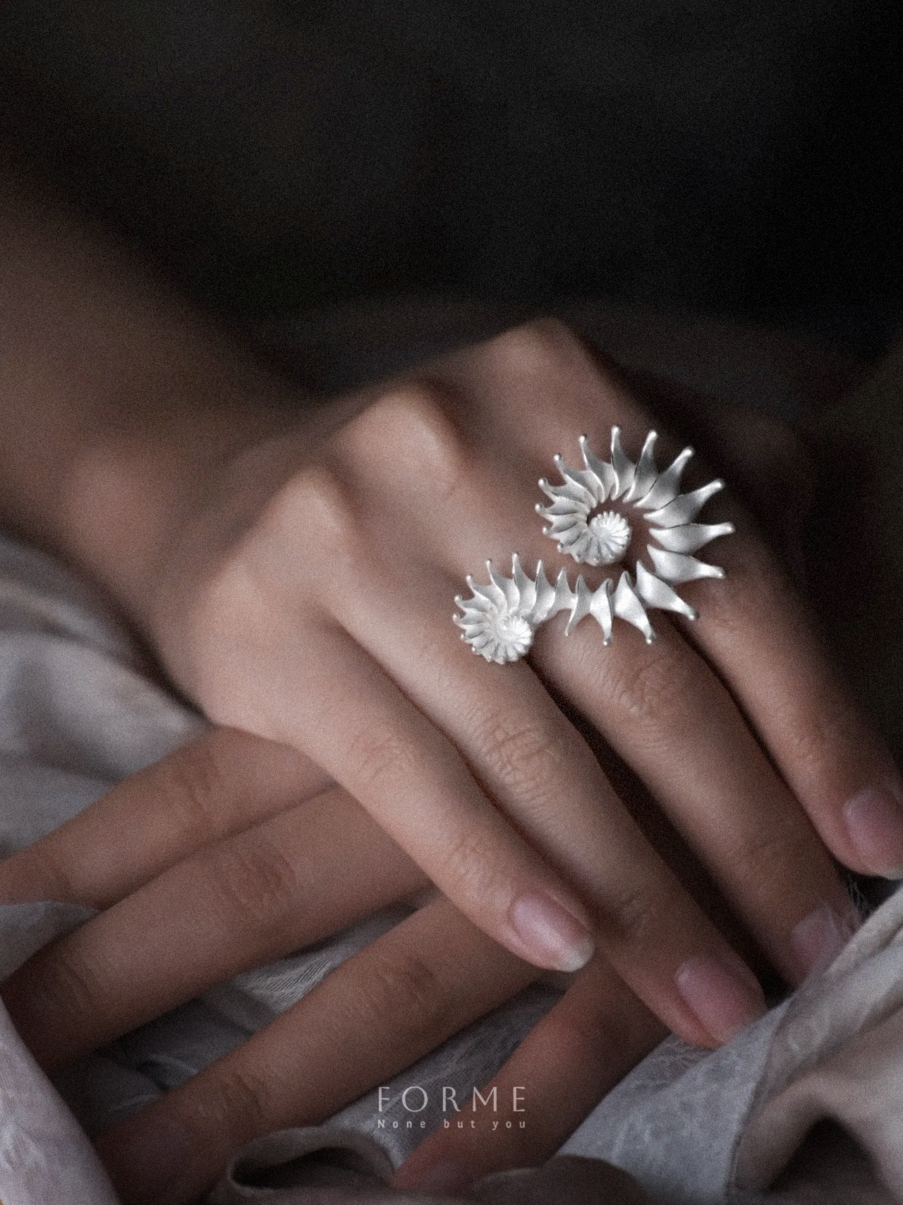 Sculptural ring symbolizing connection and duality